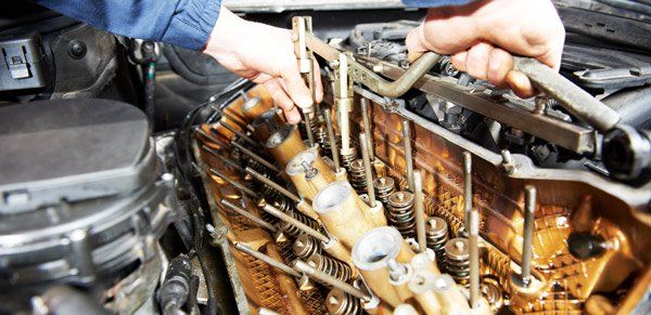 mechanic working on engine top end